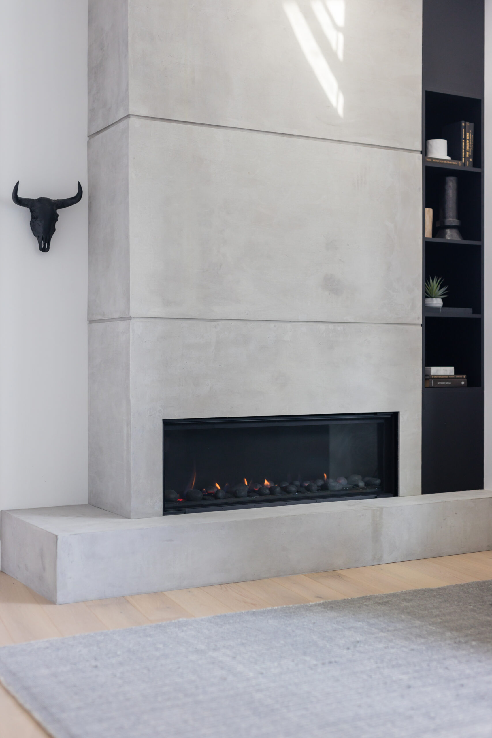 condo fireplace renovation feature custom concrete paneling