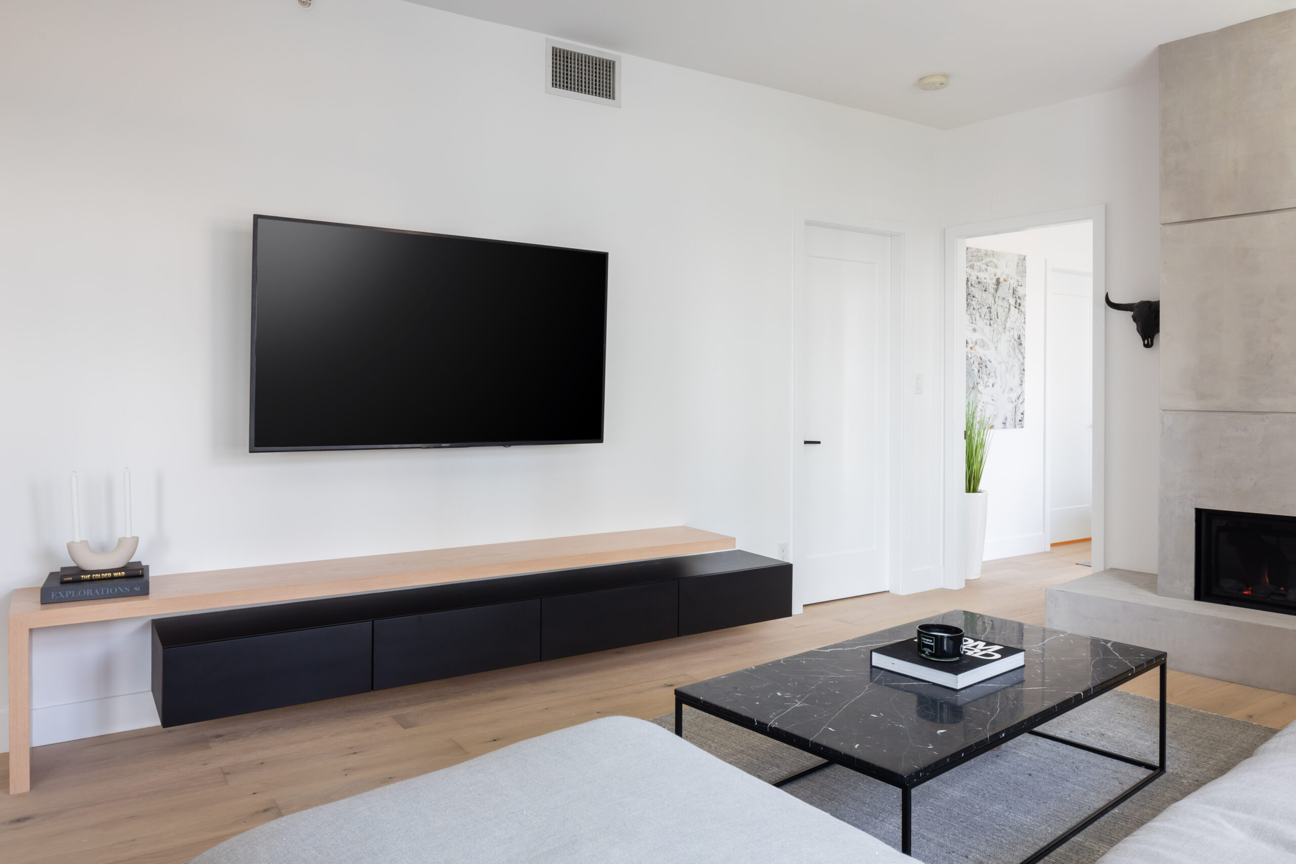 custom media console with black storage cabinets and oak top