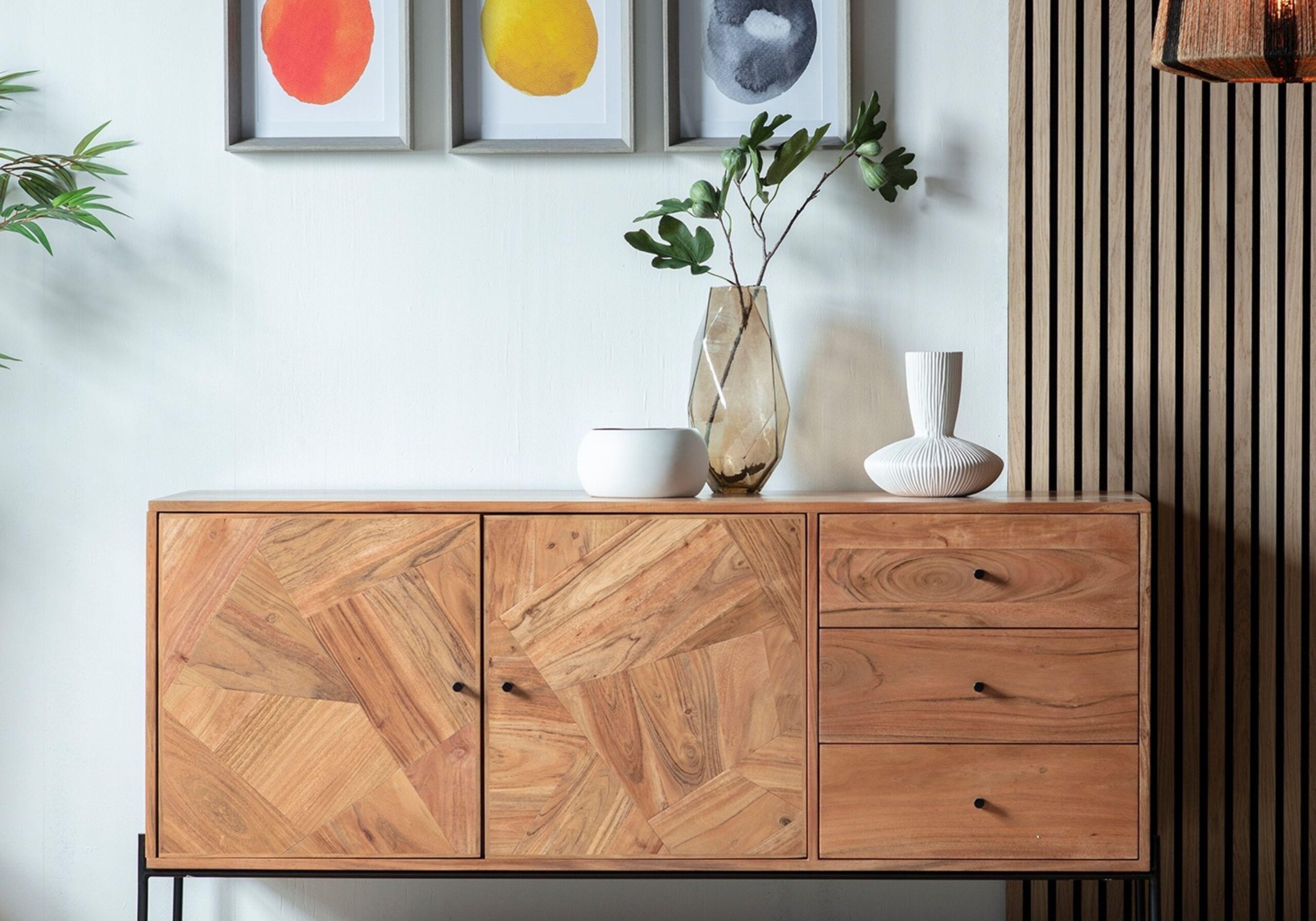 oak dresser in front of a wall slats in living room