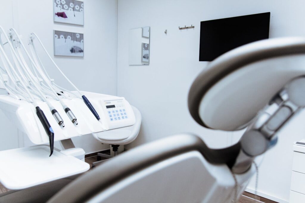 dentist office with white walls and grey dentist chair