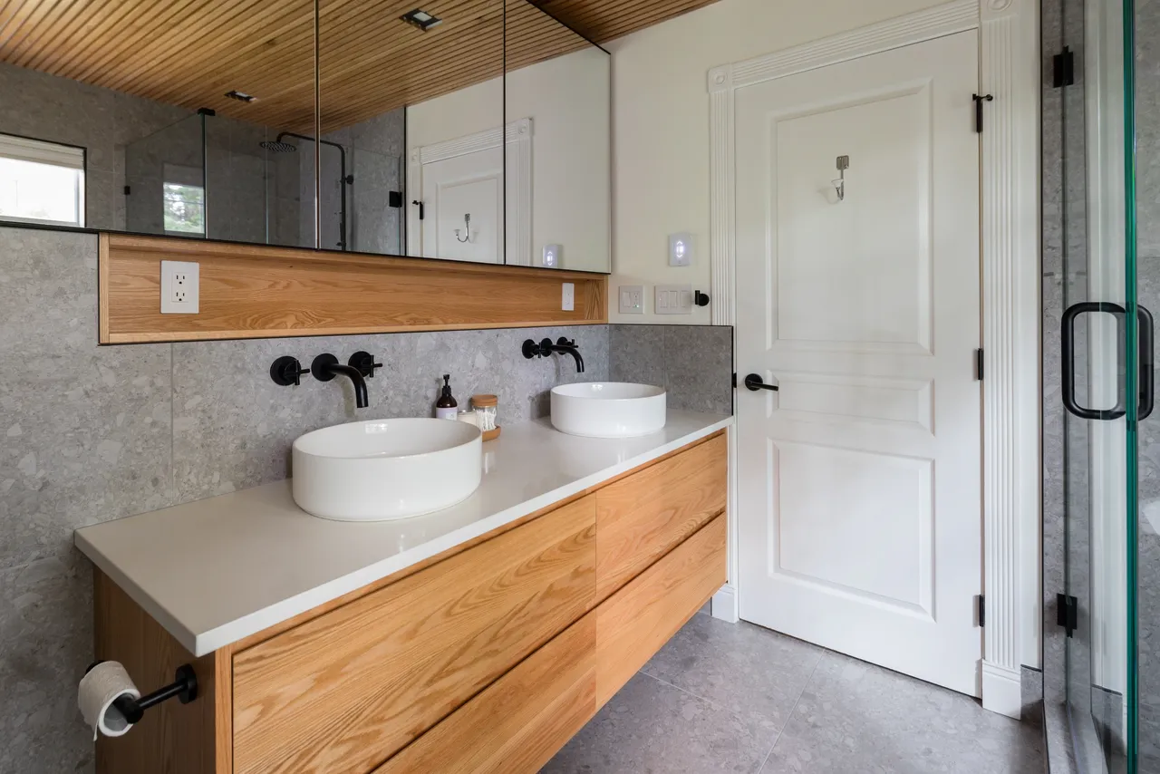 Oak double vanity with vessel sinks and wall-mount faucets