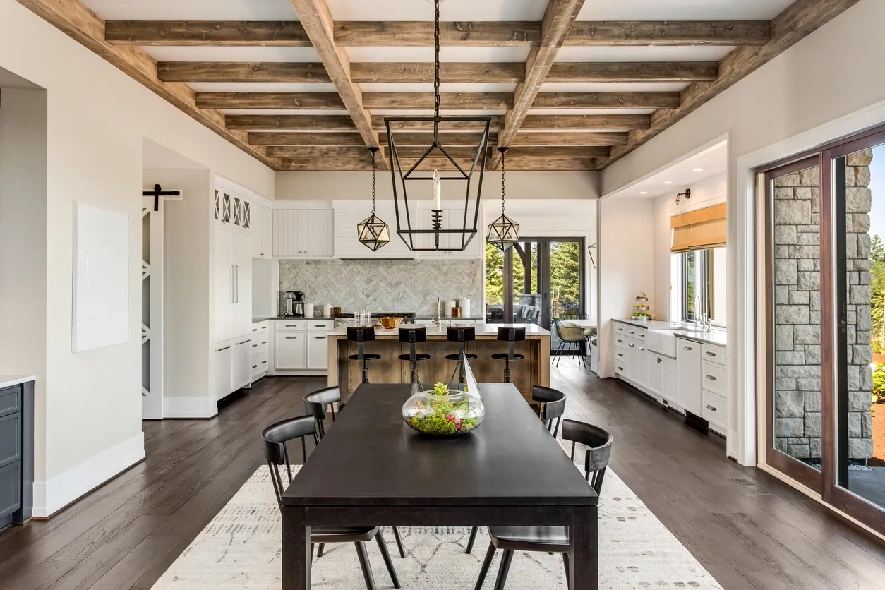 A traditional kitchen with white cabinets and herringbone marble backsplashes