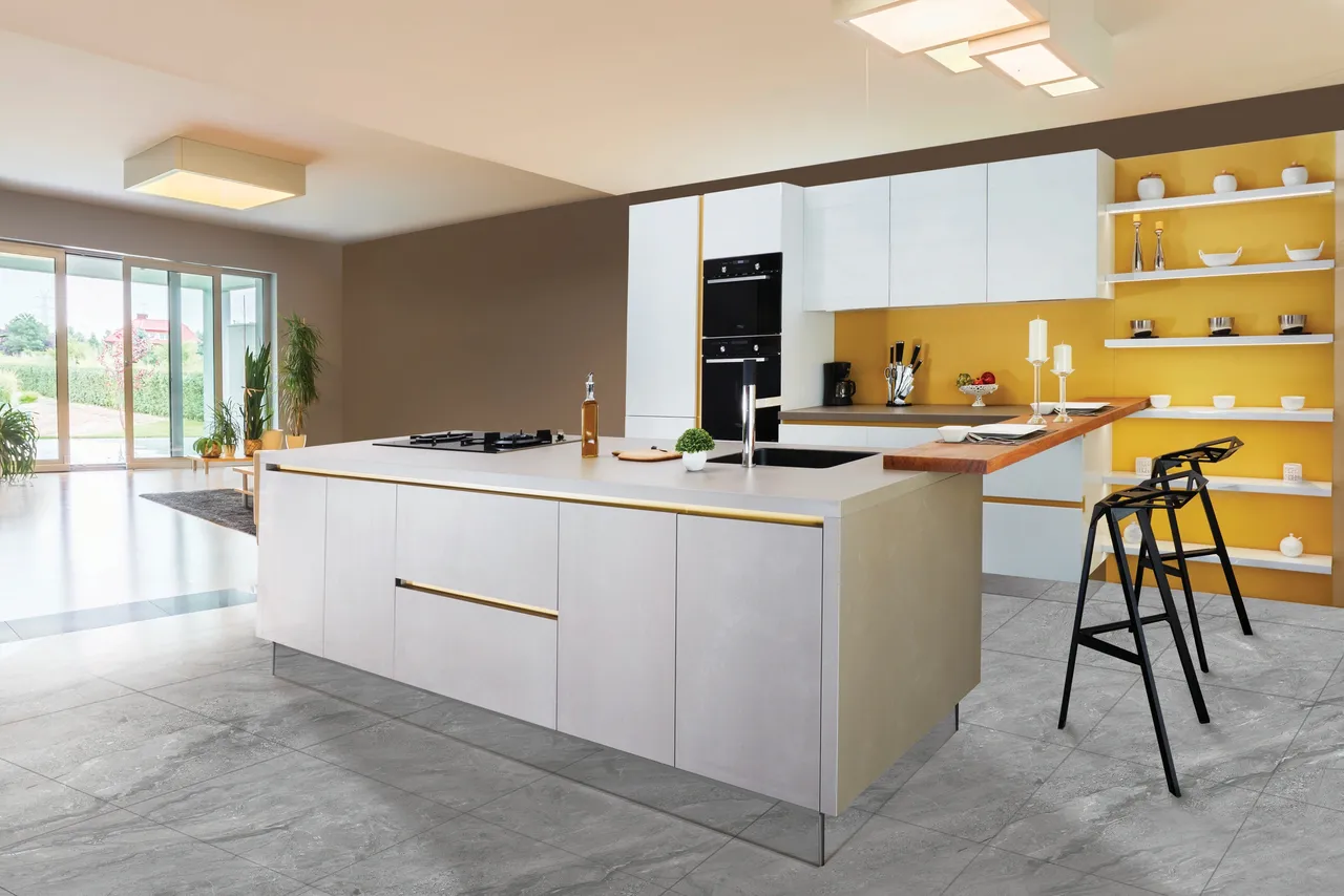 big kitchen with white island and gold feature wall