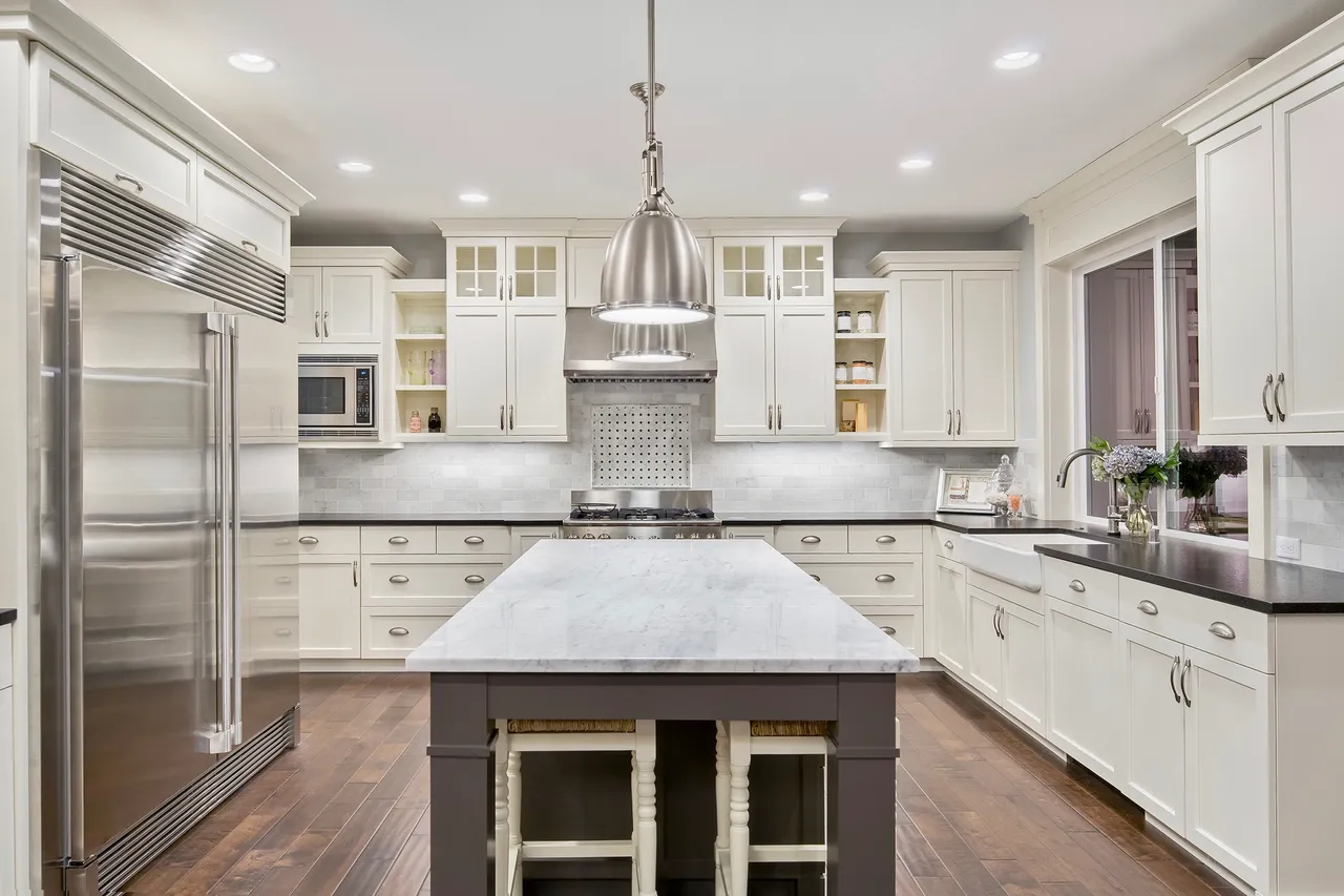 white kitchen with commercial fridge and appliances