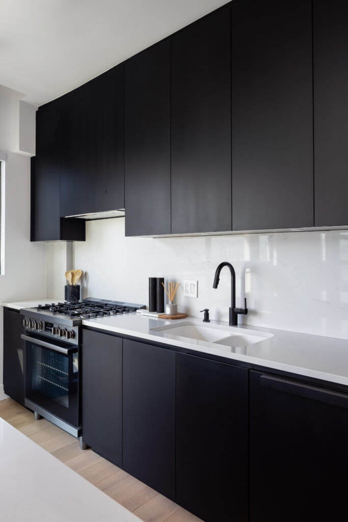 custom kitchen with black cabinets and white countertops