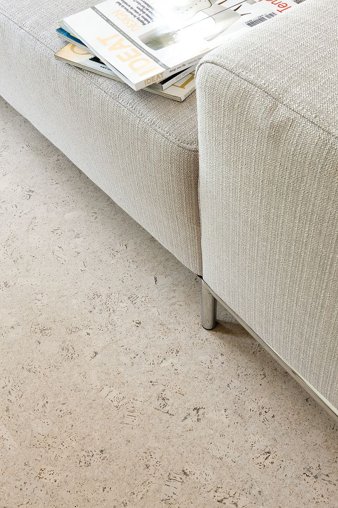 living room with cork flooring and white sofa