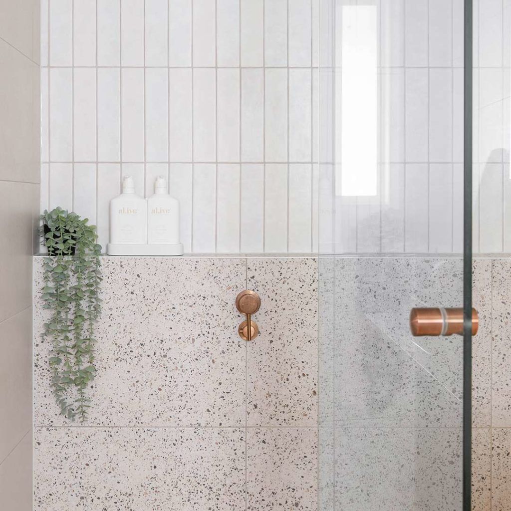 shower with terrazzo and white wall tiles