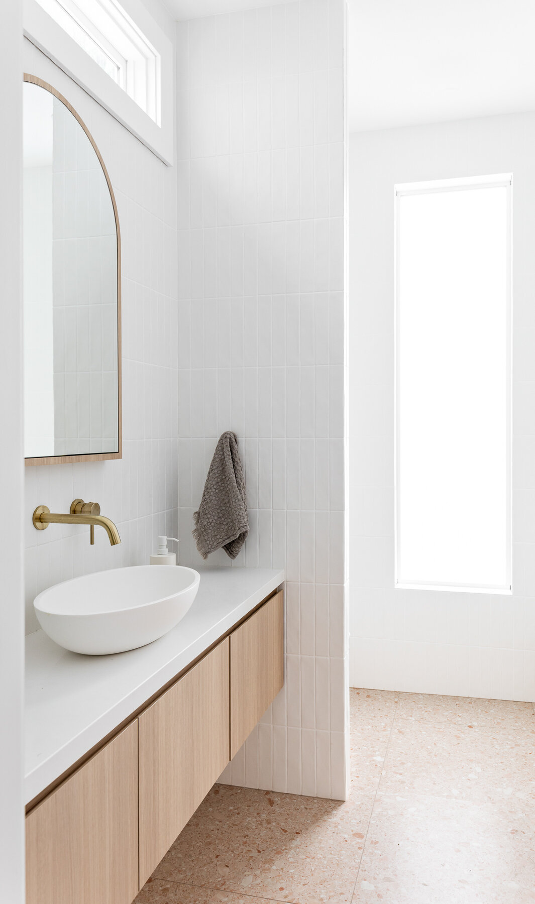 Vancouver Bathroom Renovation featuring oak floating vanity and gold arch mirror