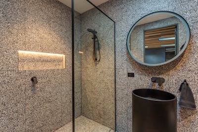 Bathroom renovation Richmond featuring grey wall tiles and custom niche