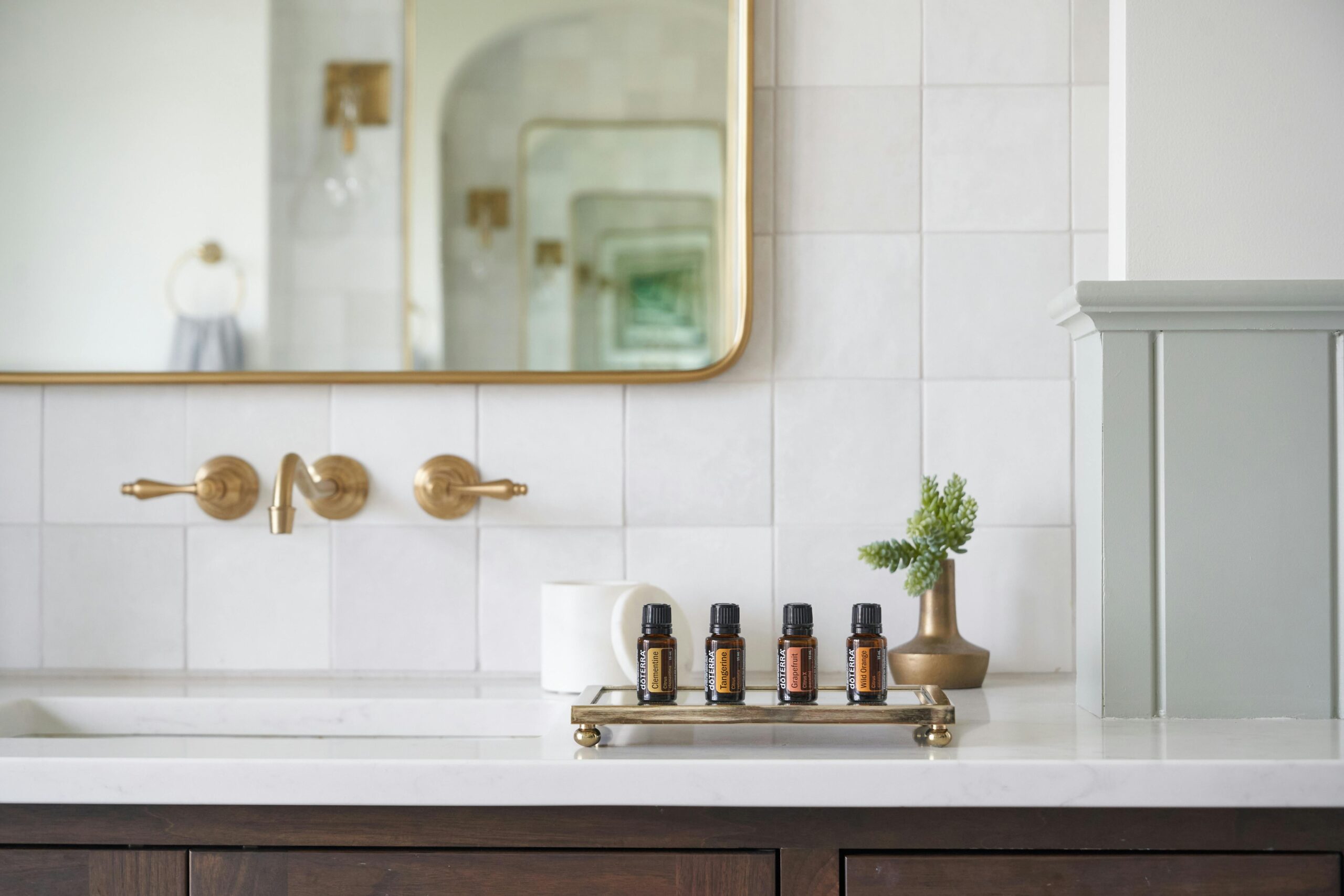 Bathroom Renovation Vancouver featuring white tiles and gold fixtures