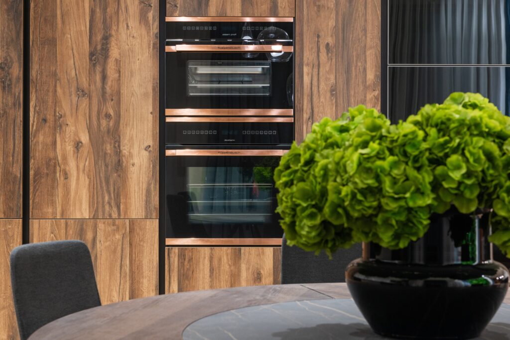 Kitchen renovation Vancouver featuring walnut cabinets and built-in oven