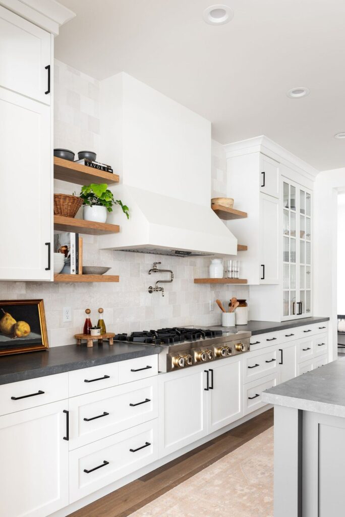 Vancouver transitional kitchen with white cabinets and dark countertops