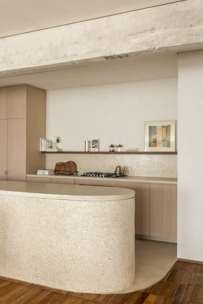 wabi-sabi kitchen with curved stone island