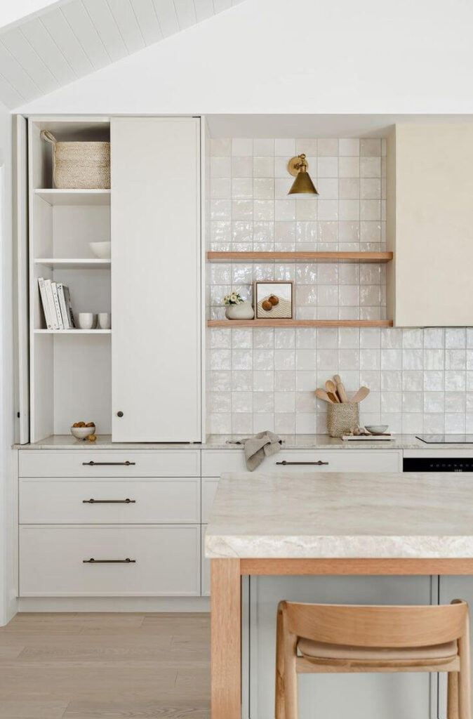 Modern kitchen renovation in West Vancouver with custom white cabinetry and marble countertops