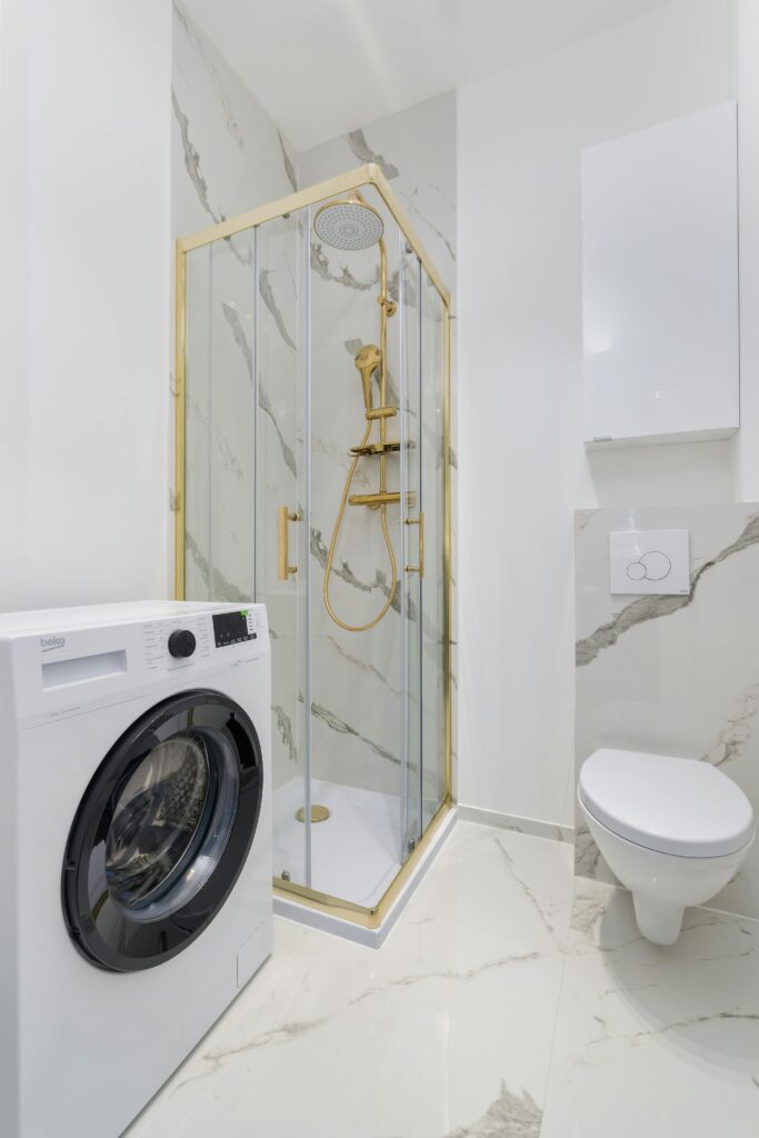 Space-saving corner shower with glass doors in compact Vancouver bathroom