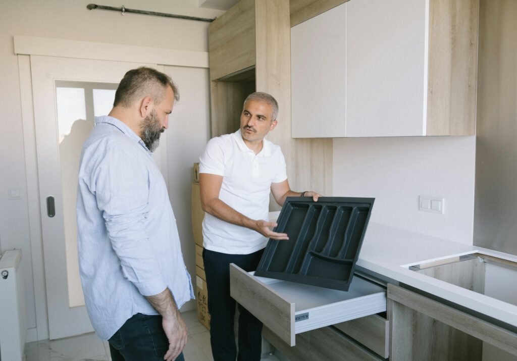 Construction worker installing kitchen cabinets in Vancouver renovation