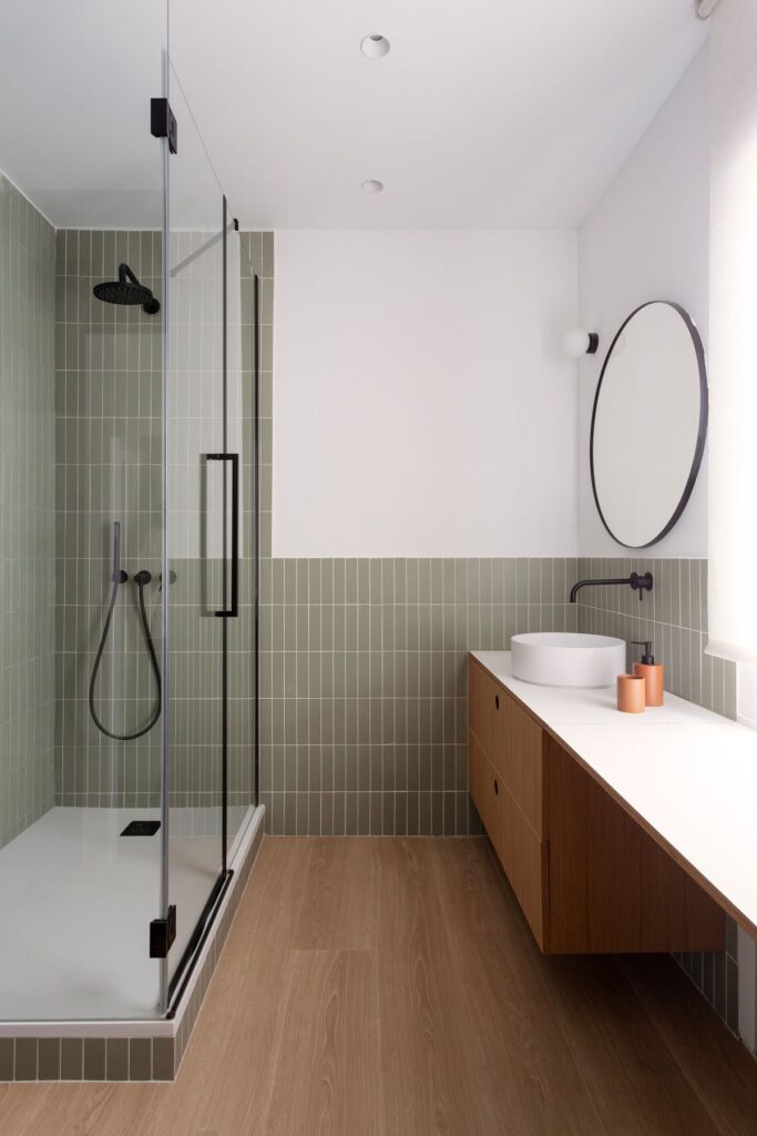Vancouver bathroom with vinyl flooring and green subway tiles