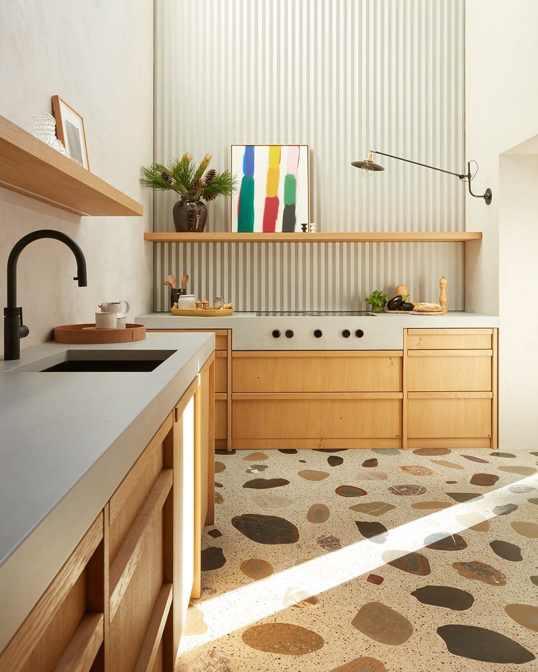 Modern Terrazzo Kitchen with white oak cabinets and green wallpaper
