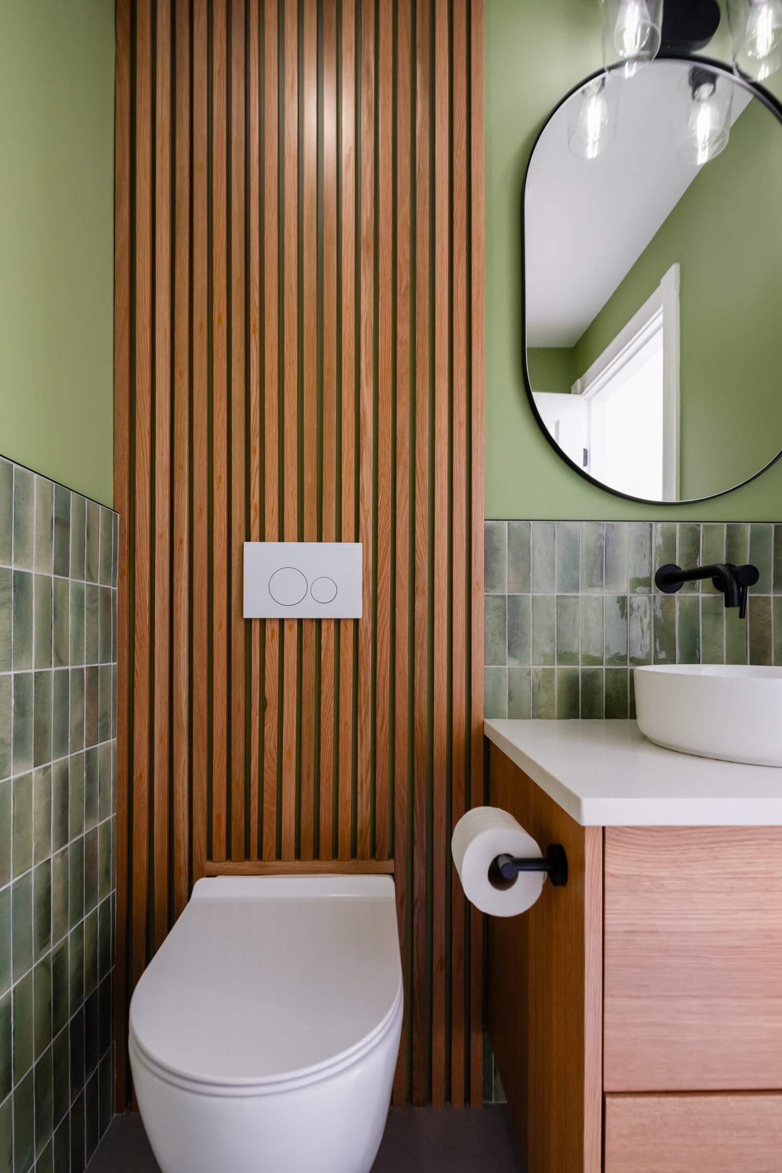 powder room renovation by QUAY featuring green subway tiles and oak wall paneling