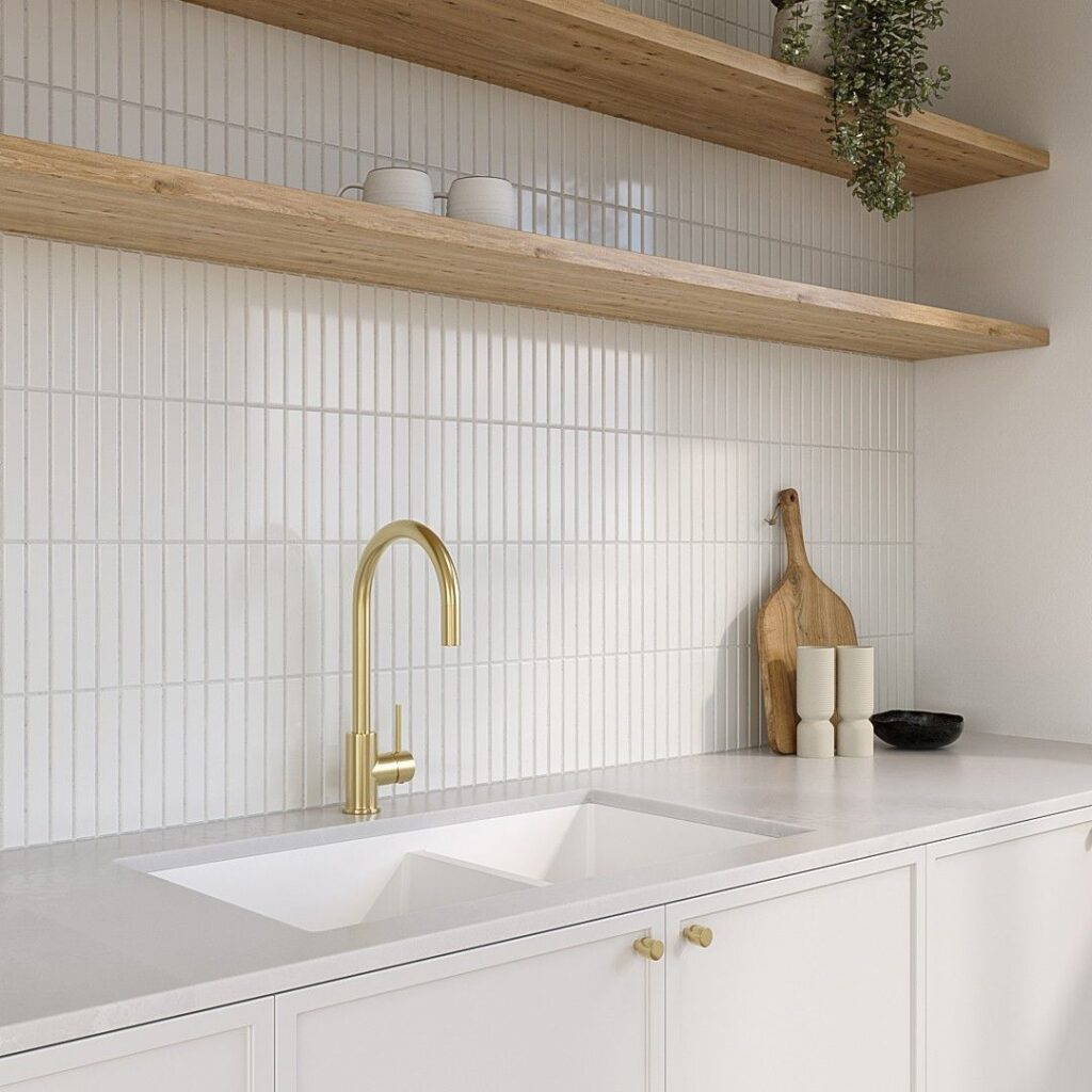 Modern kitchen renovation in Coquitlam with light wood cabinetry, white quartz countertop, and vertical subway tile backsplash.