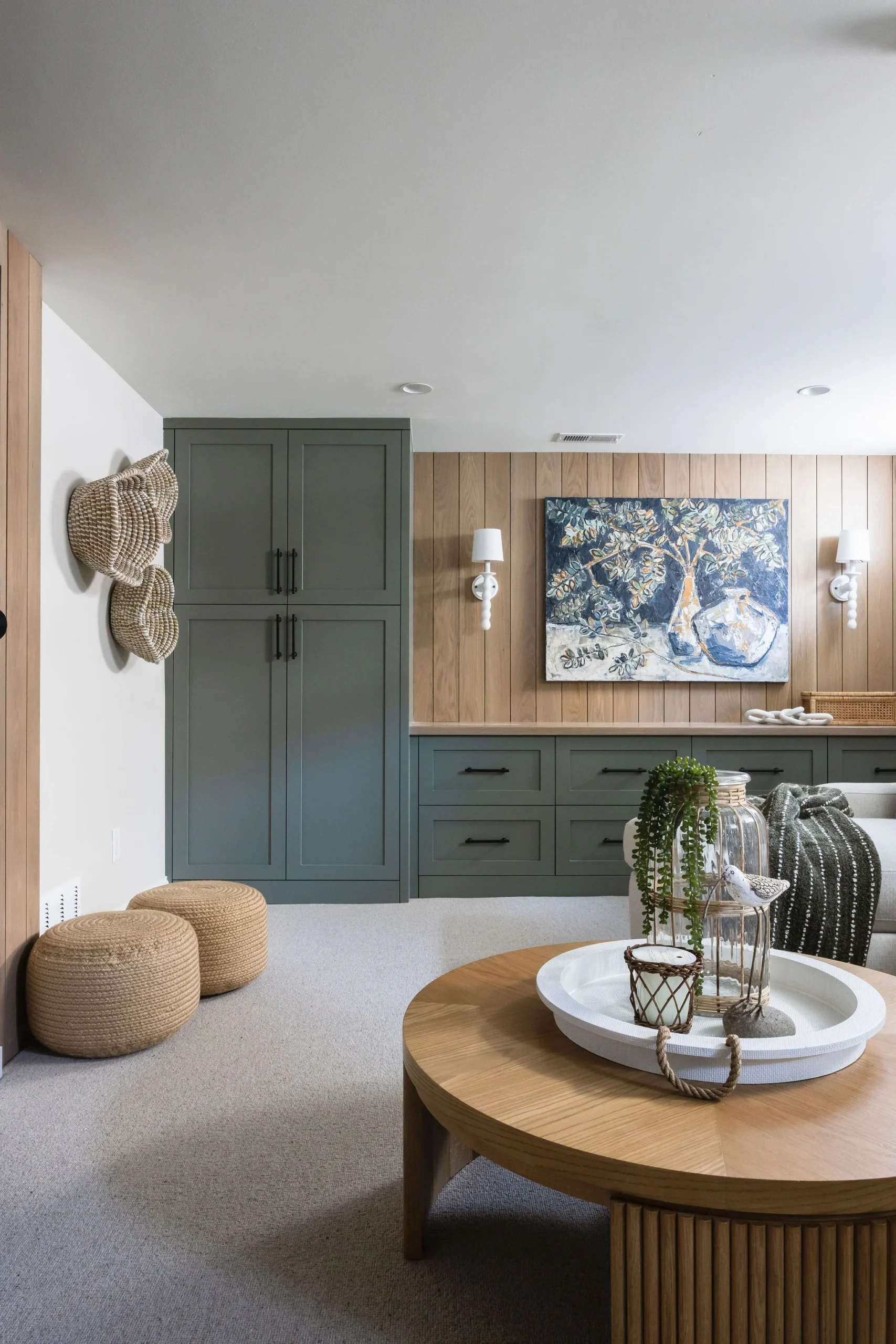 Modern basement bathroom renovation by Quay Construction featuring a glass walk-in shower, marble-style tiling, and a black vanity.