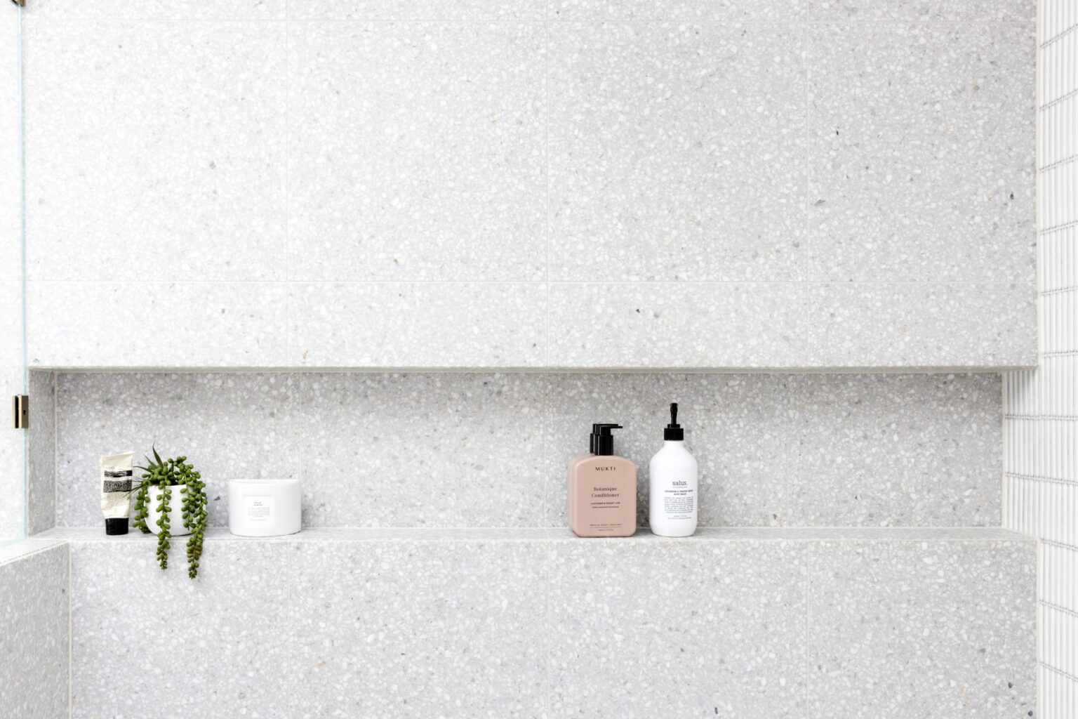 Modern bathroom renovation in Capitol Hill by Quay Construction featuring an infinity niche with large terrazzo tiles.
