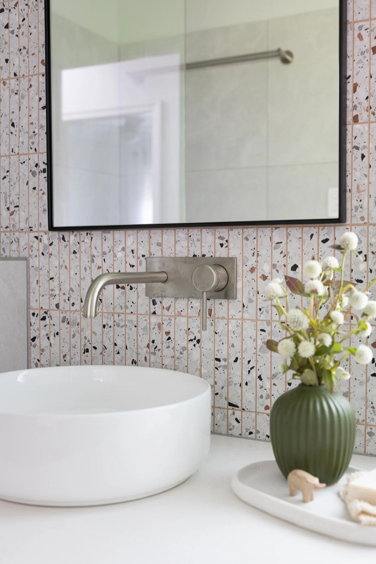 Modern bathroom featuring a vessel sink and terrazzo wall tile from a home renovation in Terra Nova by Quay Construction.
