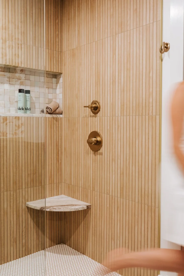 Luxury home renovation in Lower Lonsdale by Quay Construction featuring a custom walk-in closet with integrated LED lighting and minimalist oak cabinetry.