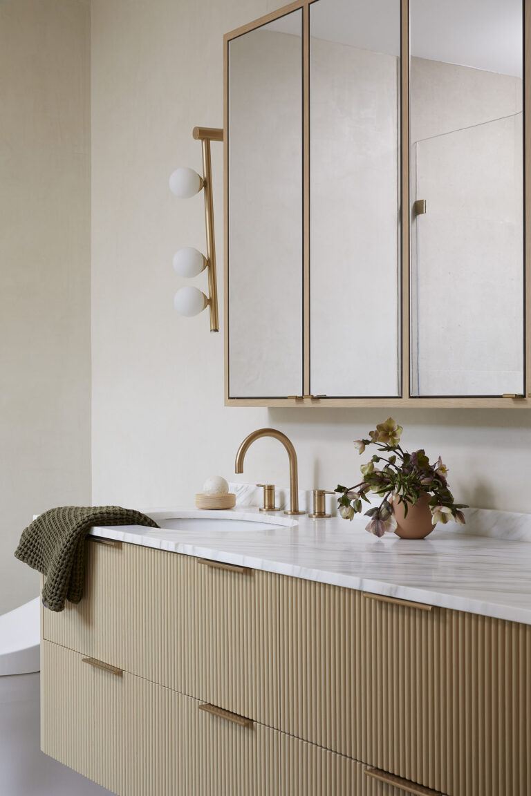 Custom bathroom vanity renovation in Lynn Valley with fluted wood and marble countertops