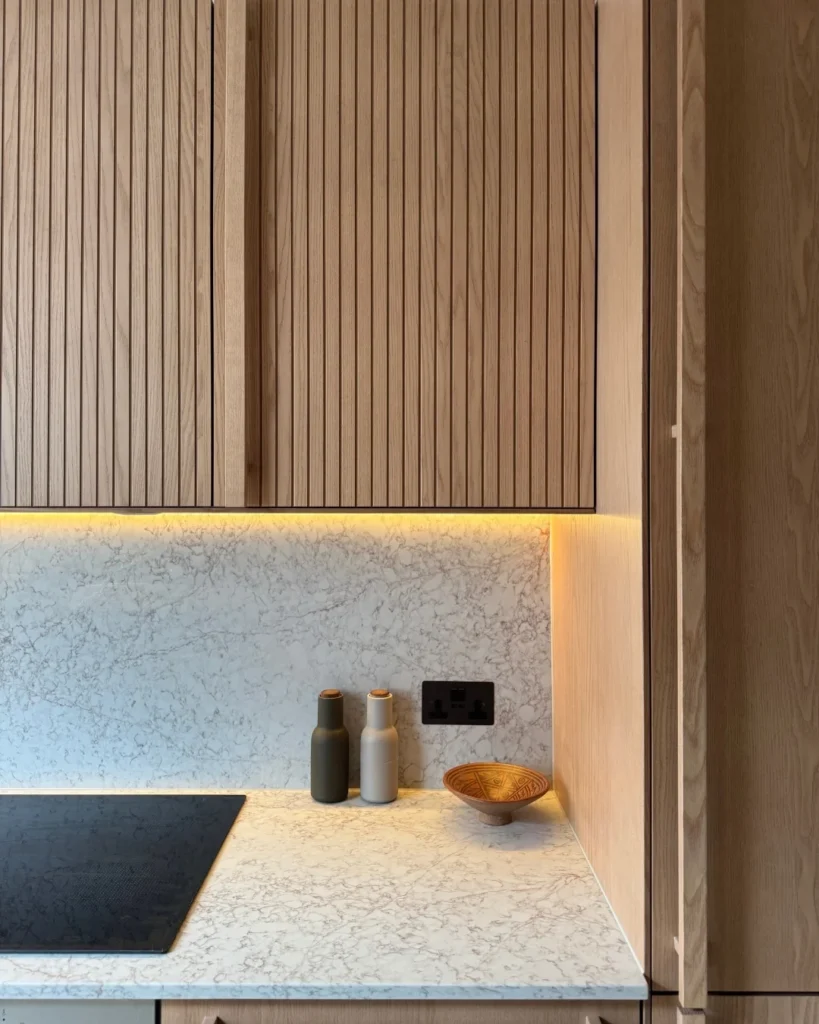 Final result of a modern condo kitchen renovation Vancouver project featuring custom cabinetry and luxury finishes by QUAY Construction.