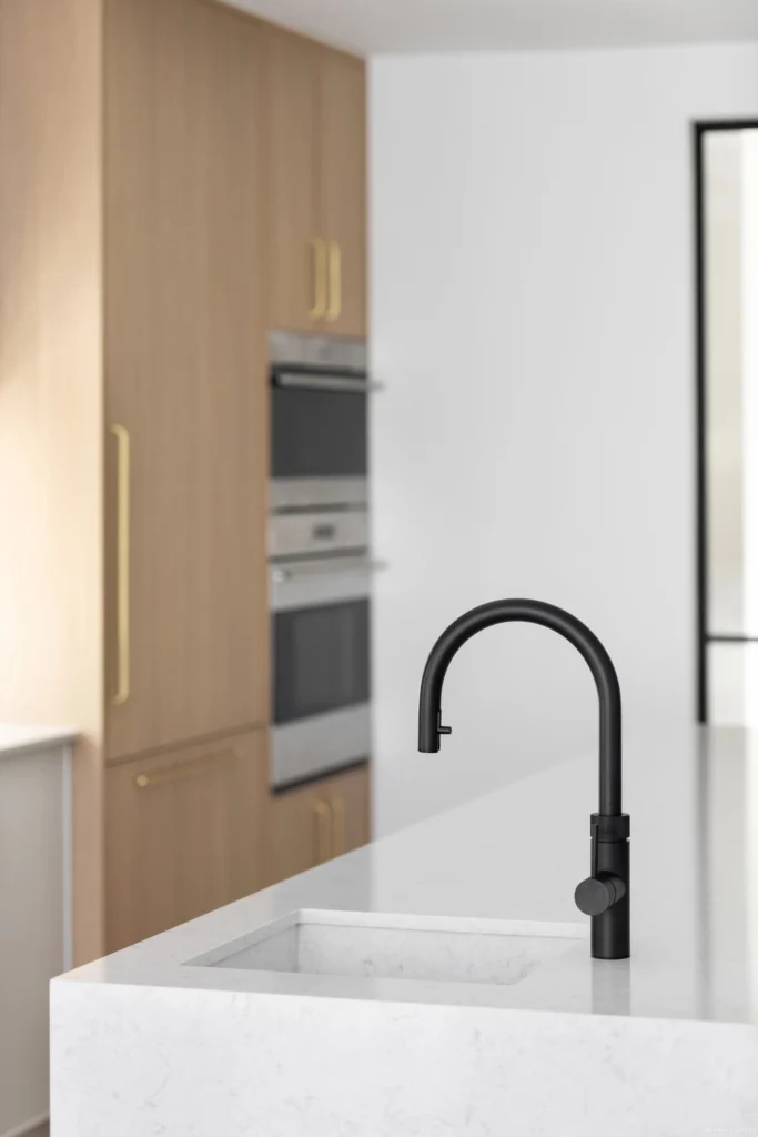 Architectural blueprints and tools for a condo kitchen renovation Vancouver project by QUAY Construction.