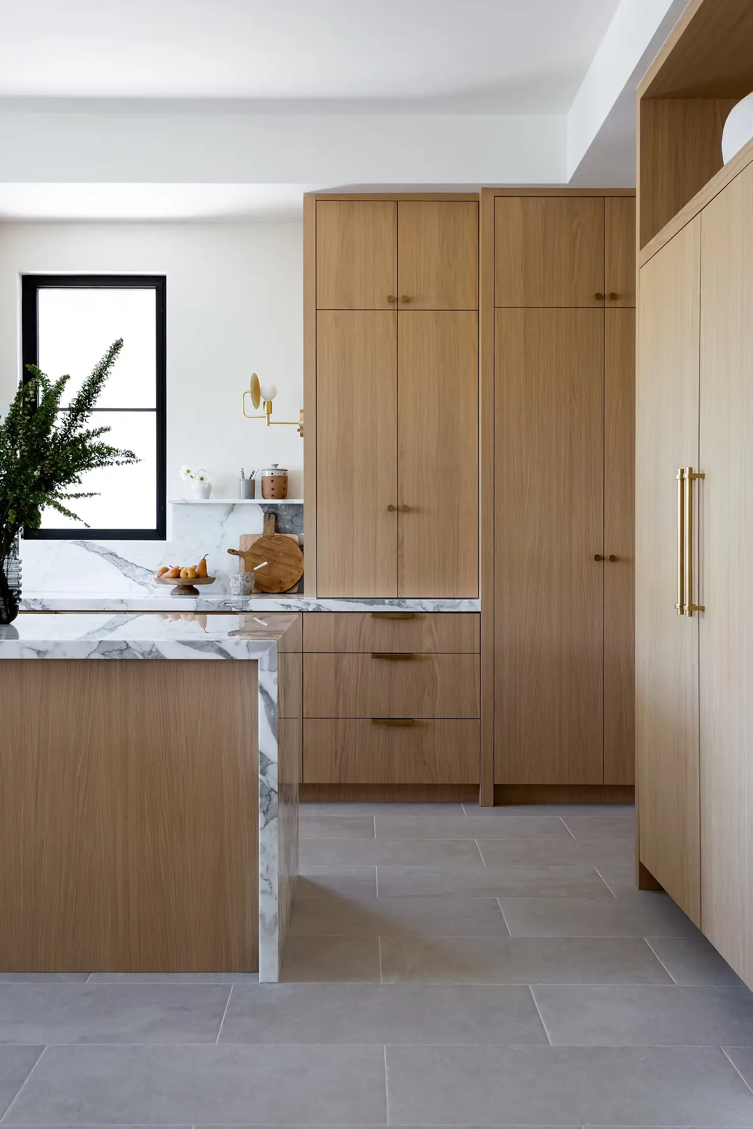 Architectural blueprints and tools for a condo kitchen renovation Vancouver project by QUAY Construction.