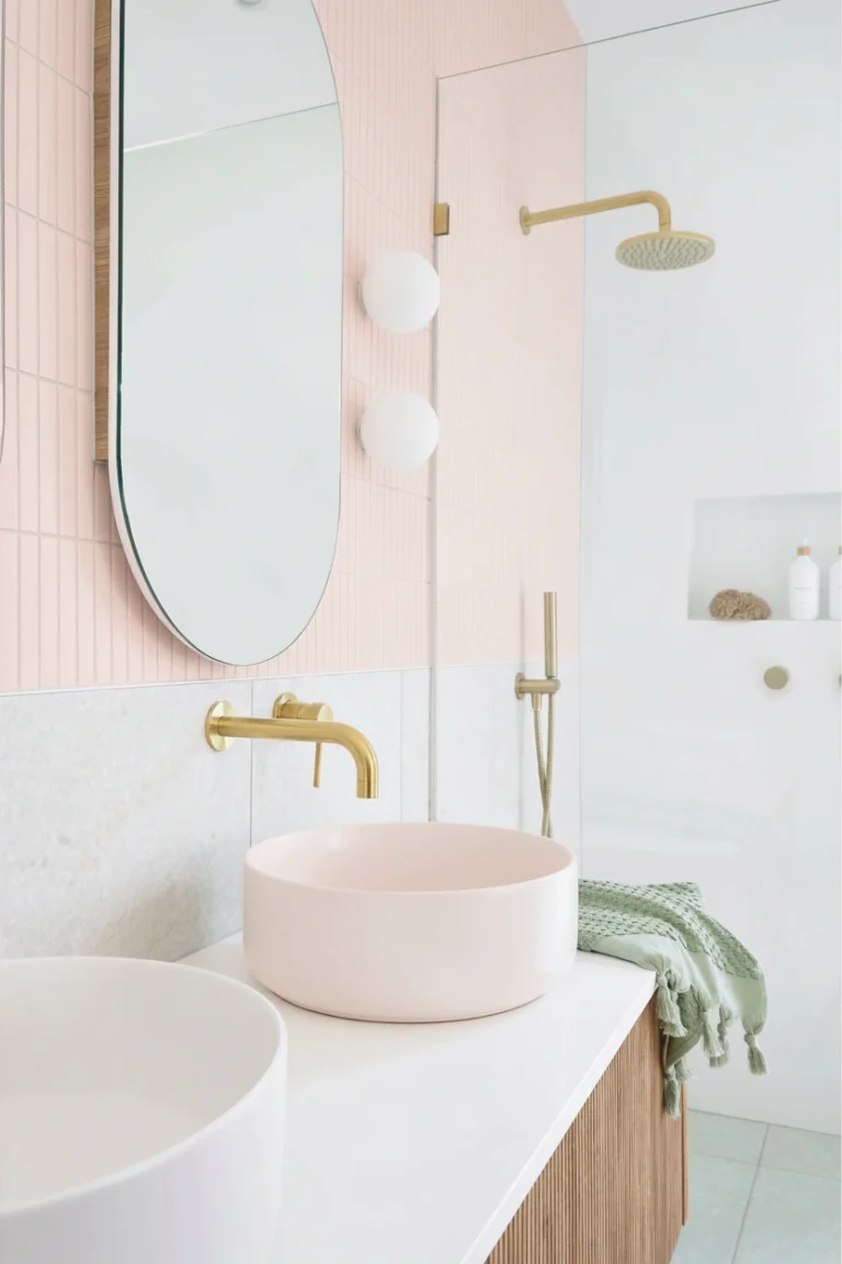Modern bathroom featuring a pink vessel sink and vertical kit kat tiles in a Dunbar-Southlands home renovation by QUAY Construction.