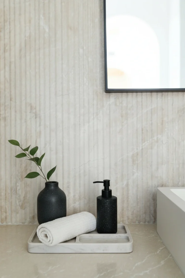 Luxury Burnaby basement renovation bathroom featuring fluted stone wall tiles, marble tray, and matte black accents.