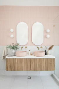 Modern bathroom double vanity with pink vessel sinks from a home renovations Lynn Valley project.