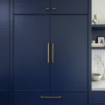 Home renovation Yaletown featuring floor-to-ceiling navy blue custom cabinetry with gold hardware by QUAY Construction.