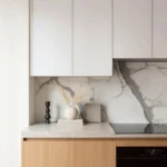 Home renovation Yaletown featuring oak lower cabinets, white uppers, and marble backsplash by QUAY Construction.