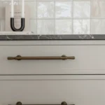 Detail of luxury kitchen cabinets and brass hardware from home renovations Lynn Valley project.