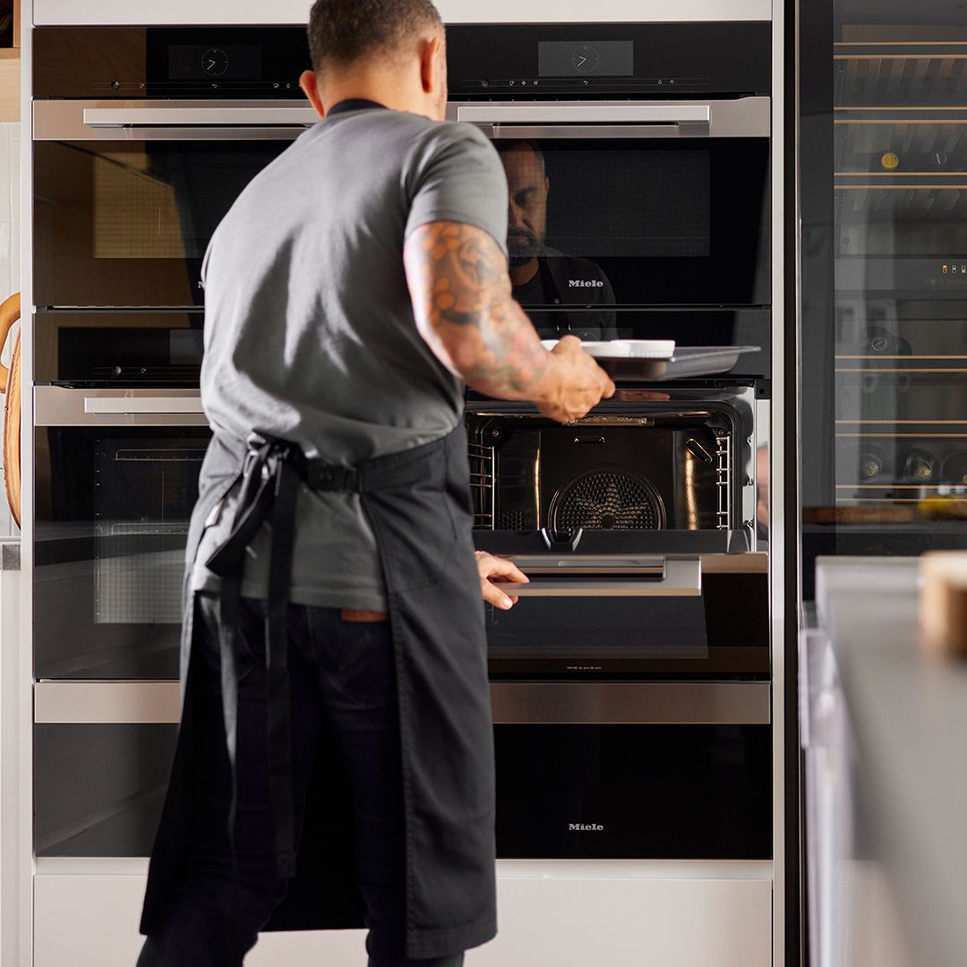 Modern kitchen renovation in Vancouver featuring white upper shaker cabinets and navy blue lower cabinetry.
