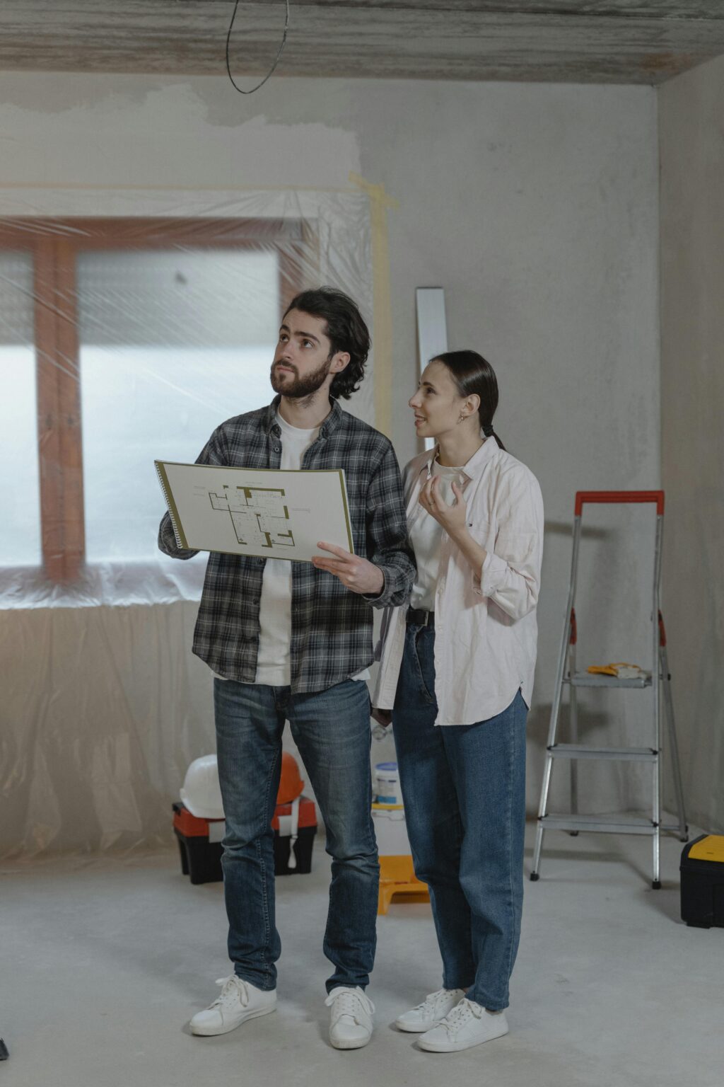 Homeowners reviewing floor plans during a kitchen renovation Vancouver project to ensure timeline accuracy.