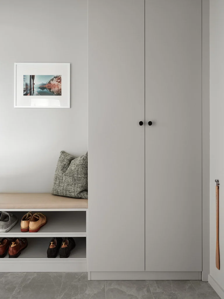 Luxury home renovation in Deer Lake featuring a custom mudroom with slatted wood details and built-in storage.