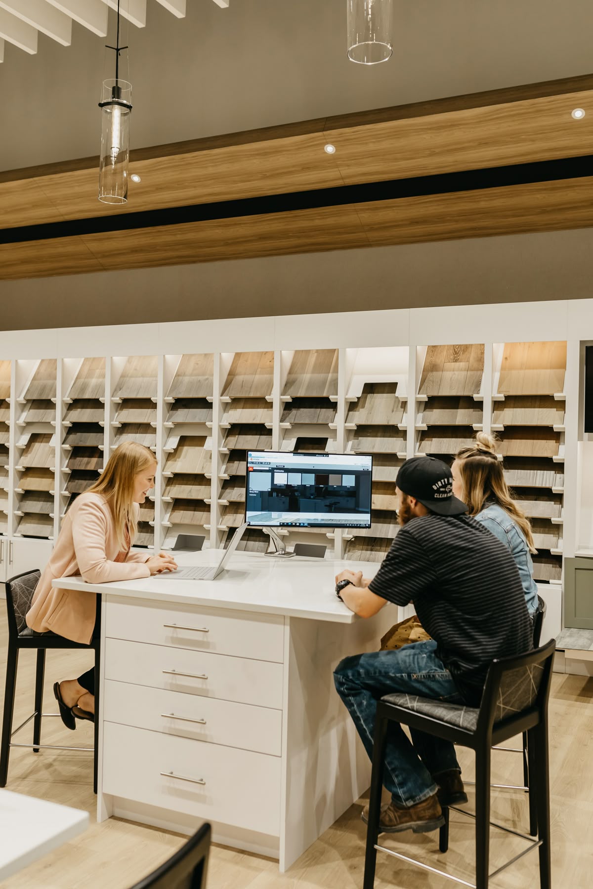 Designers and homeowners reviewing kitchen cabinet door styles in a Vancouver showroom consultation.