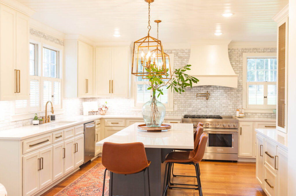 Luxury kitchen renovation Vancouver project featuring a large island with white quartz and gold pendant lighting.
