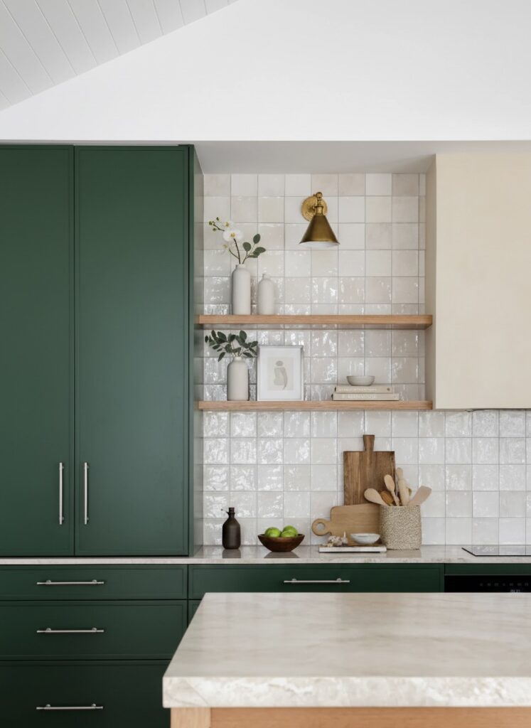 Forest green cabinetry and moisture-resistant tile backsplash in a luxury kitchen renovation Vancouver by QUAY Construction.