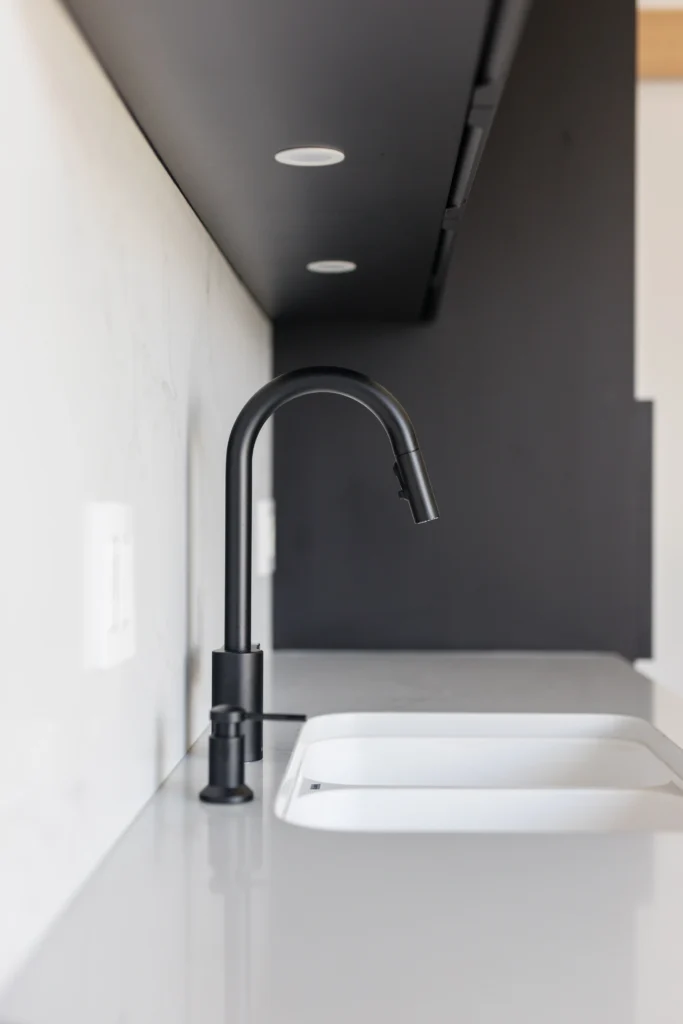 modern kitchen sink with matte black faucet and quartz countertop in Vancouver