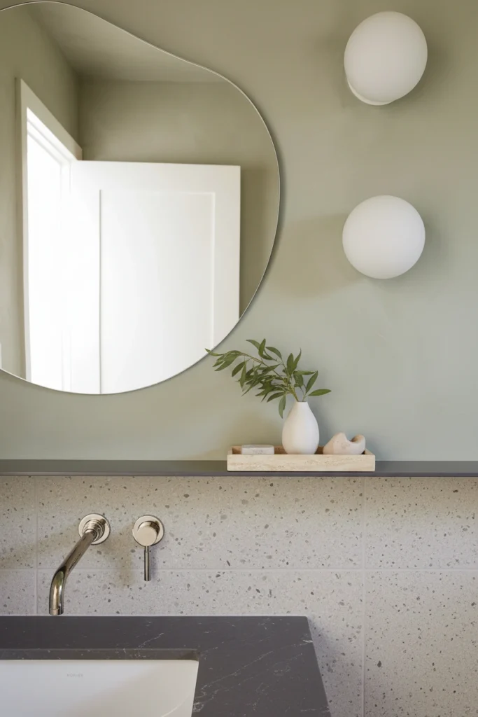 Modern vanity with best plumbing fixture brands for a luxury bathroom renovation, featuring a wall-mounted faucet.