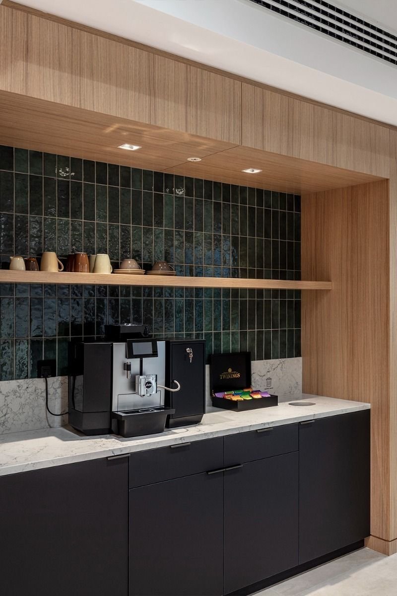 Modern office kitchen renovation with custom cabinetry and employee amenities