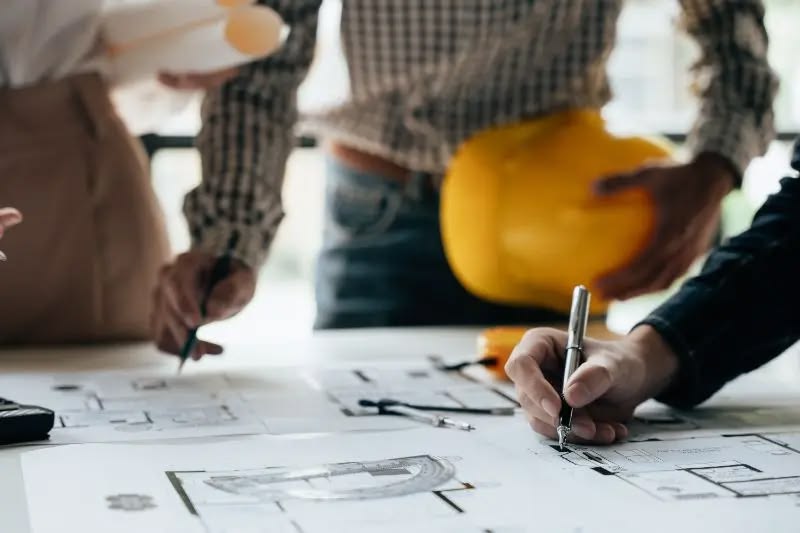Contractor reviewing bathroom renovation plans with project documents before construction in Vancouver