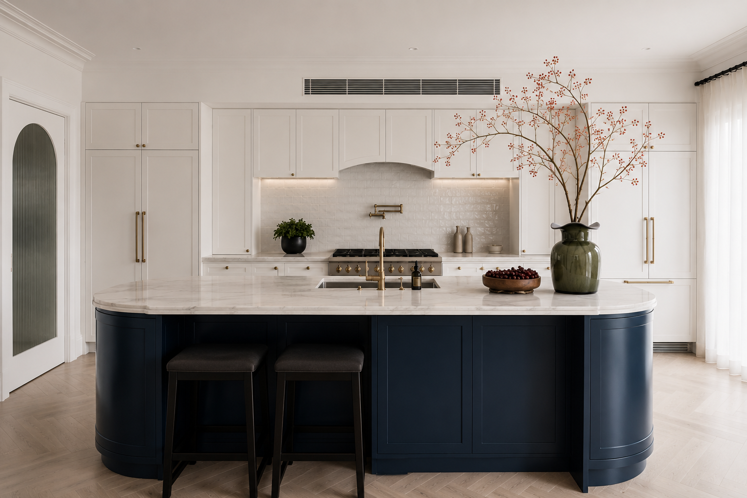 Completed luxury kitchen renovation in Chartwell West Vancouver featuring a curved navy island, custom white cabinetry, stone countertops and brass fixtures