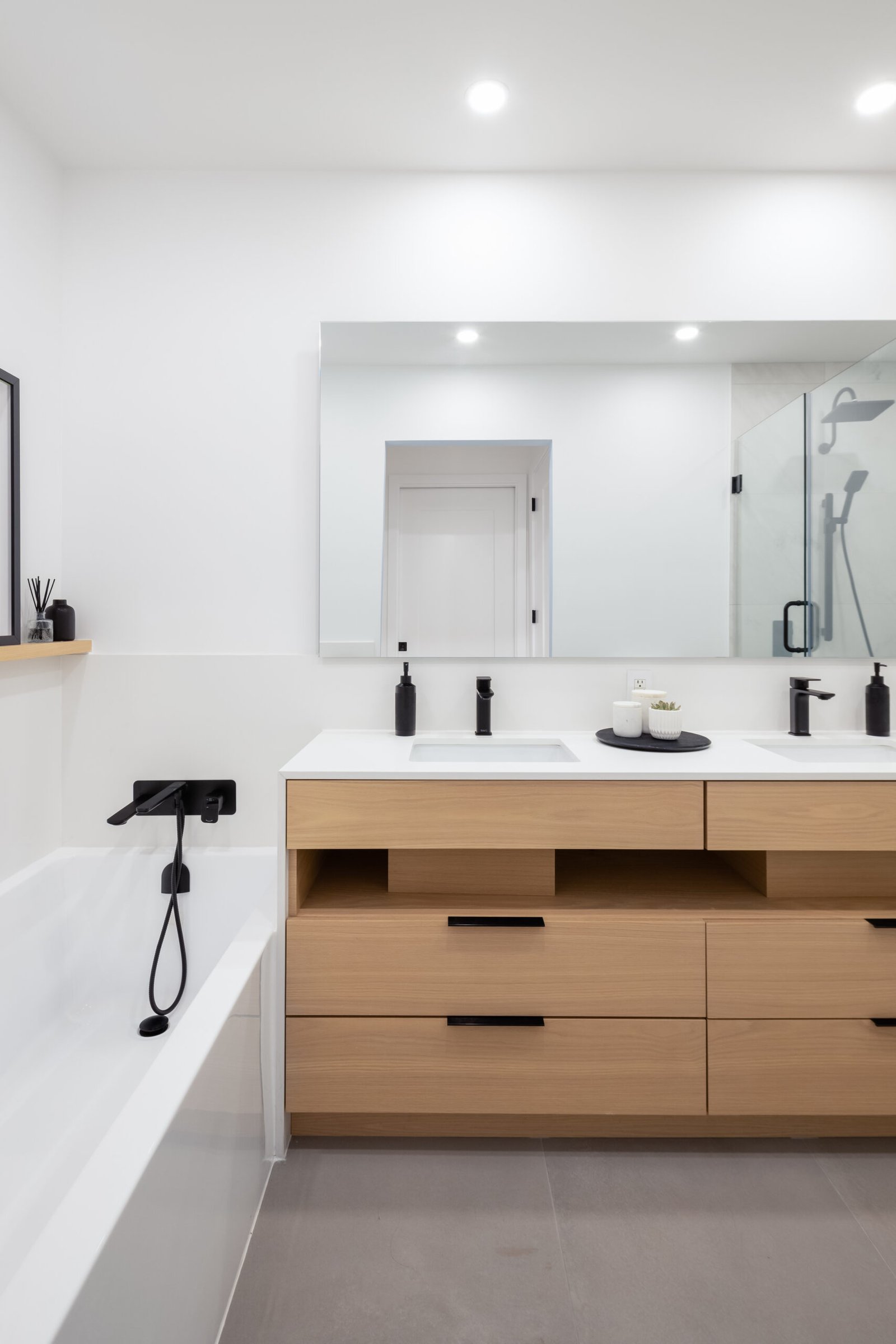 Modern bathroom renovation in a Downtown Vancouver condo featuring contemporary tile, vanity and plumbing fixtures